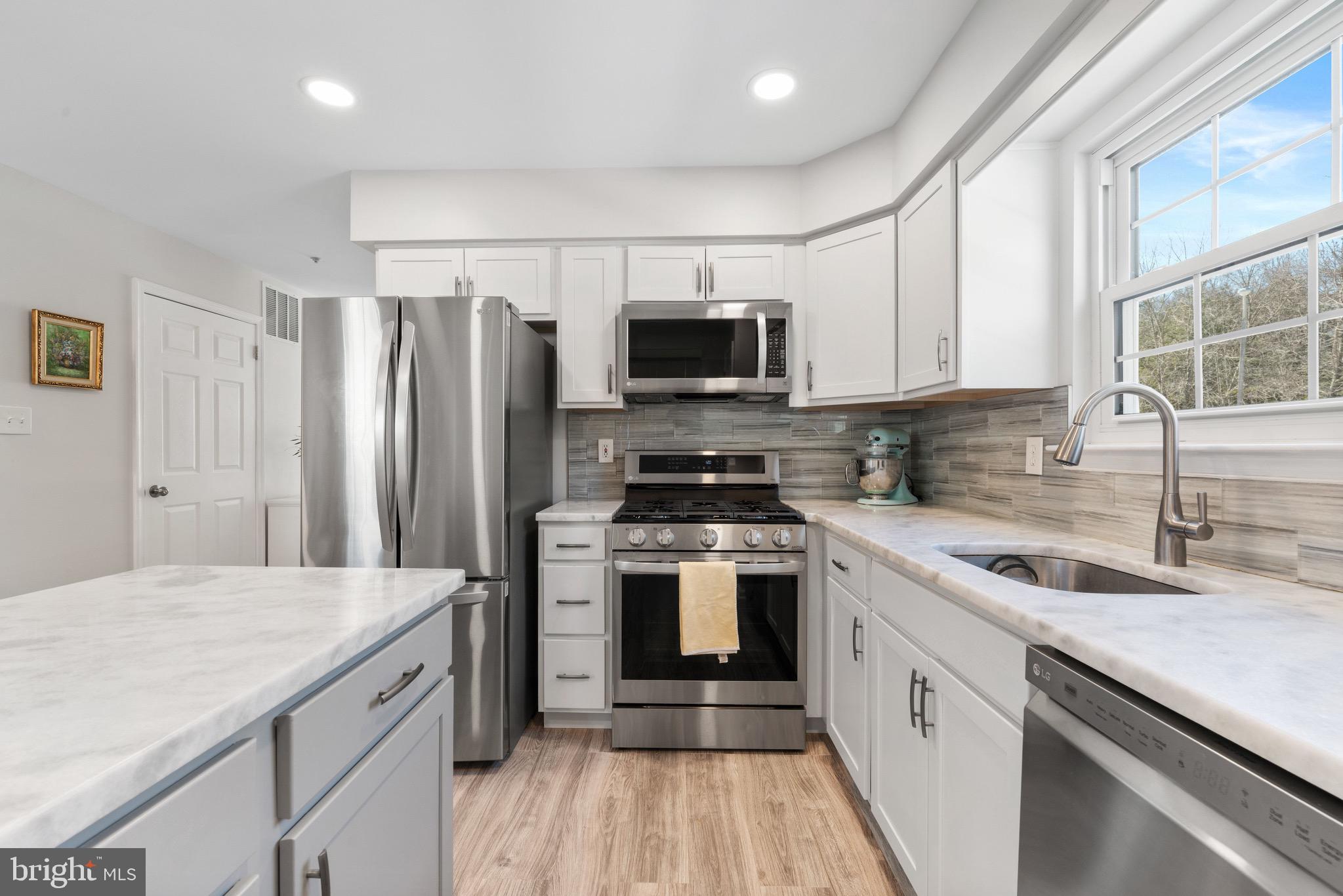135 Buckingham Way Mount Laurel, NJ 08054 - Photo 15 of 30 a kitchen with a sink stove and refrigerator