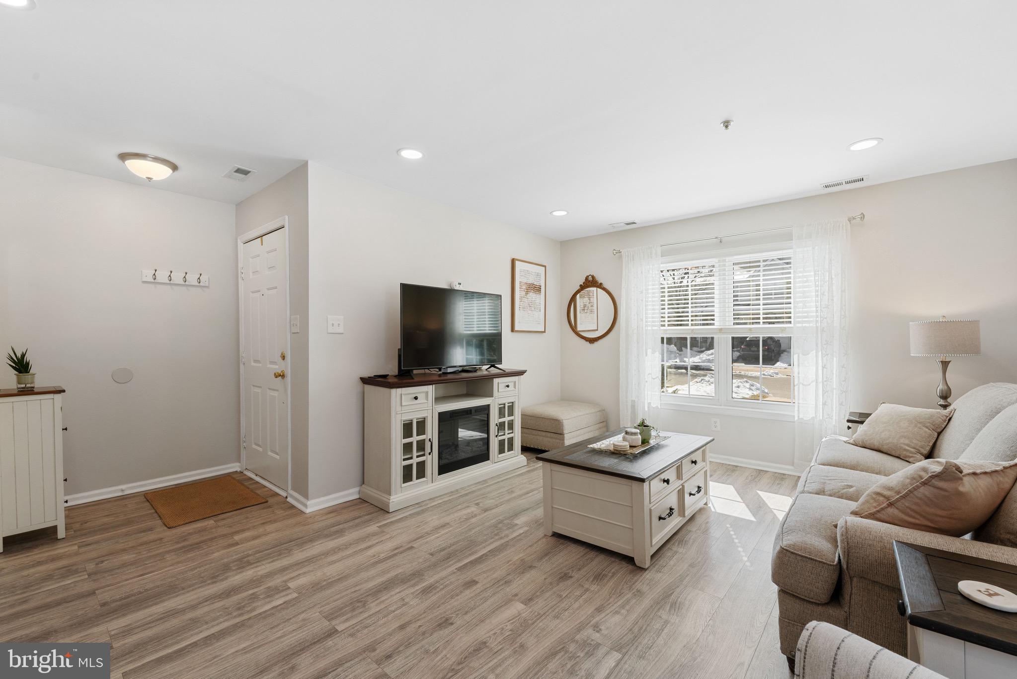 135 Buckingham Way Mount Laurel, NJ 08054 - Photo 6 of 30 a living room with furniture flat screen tv and a window