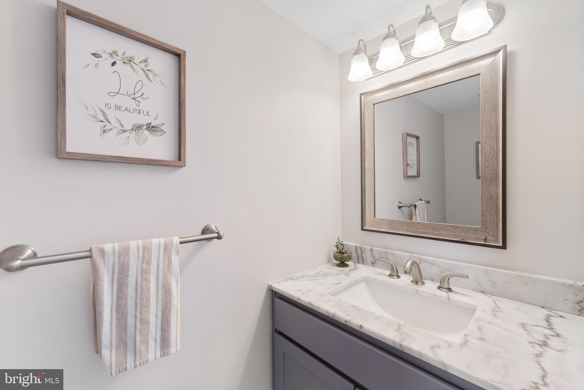 135 Buckingham Way Mount Laurel, NJ 08054 - Photo 10 of 30 a bathroom with a granite countertop sink a mirror and a picture on the wall