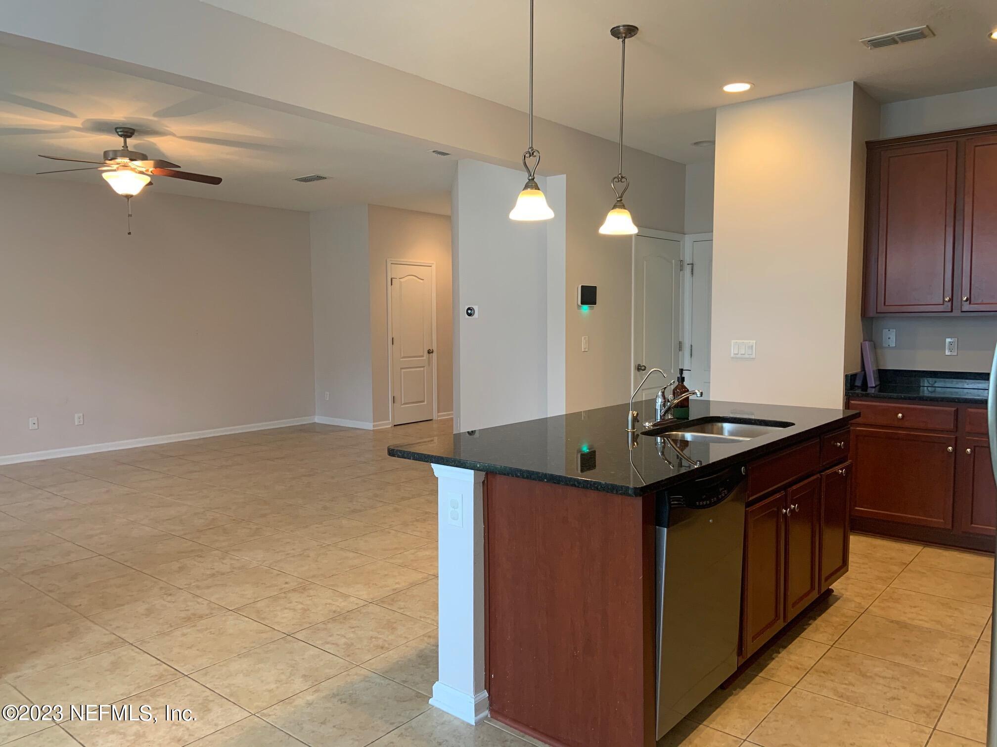3863 Chasing Falls Road Orange Park, FL 32065 - Photo 17 of 32 a kitchen with a sink and chandelier