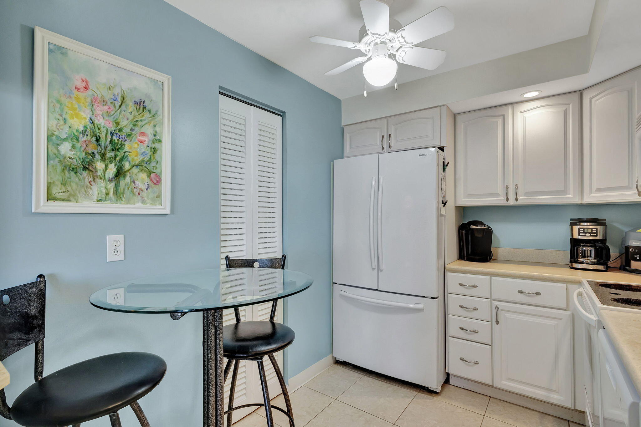 2800 North Ocean Drive, Unit A24B Singer Island, FL 33404 - Photo 12 of 65 a kitchen with stainless steel appliances white cabinets and a refrigerator