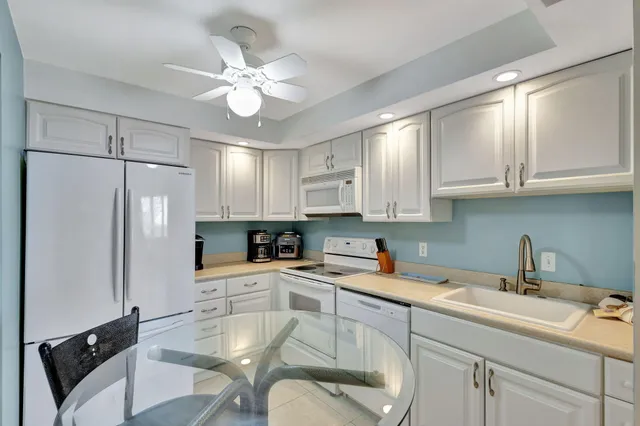 a bedroom with a bed and a lamp on dresser