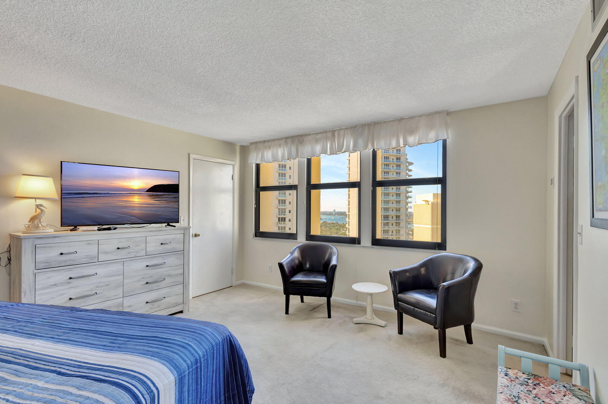 2800 North Ocean Drive, Unit A24B Singer Island, FL 33404 - Photo 17 of 65 a bedroom with a bed and a flat screen tv