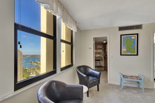 a spacious bathroom with a granite countertop sink a toilet a mirror and bathtub