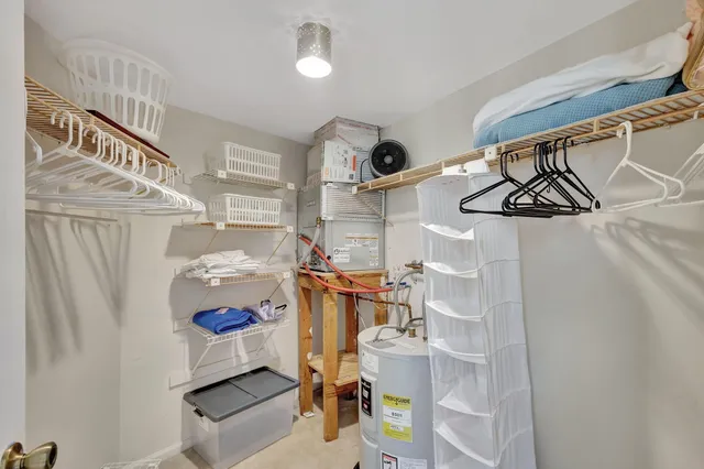 a bedroom with a bed and a lamp next to a window