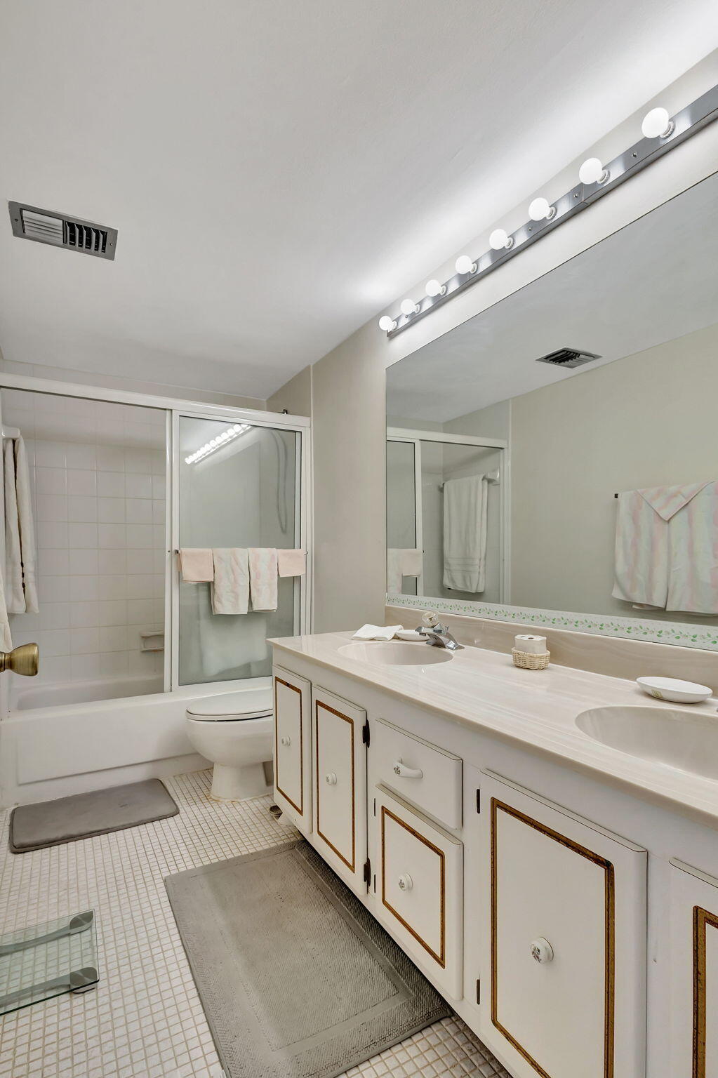 2800 North Ocean Drive, Unit A24B Singer Island, FL 33404 - Photo 22 of 65 a spacious bathroom with a granite countertop sink a toilet a mirror and bathtub
