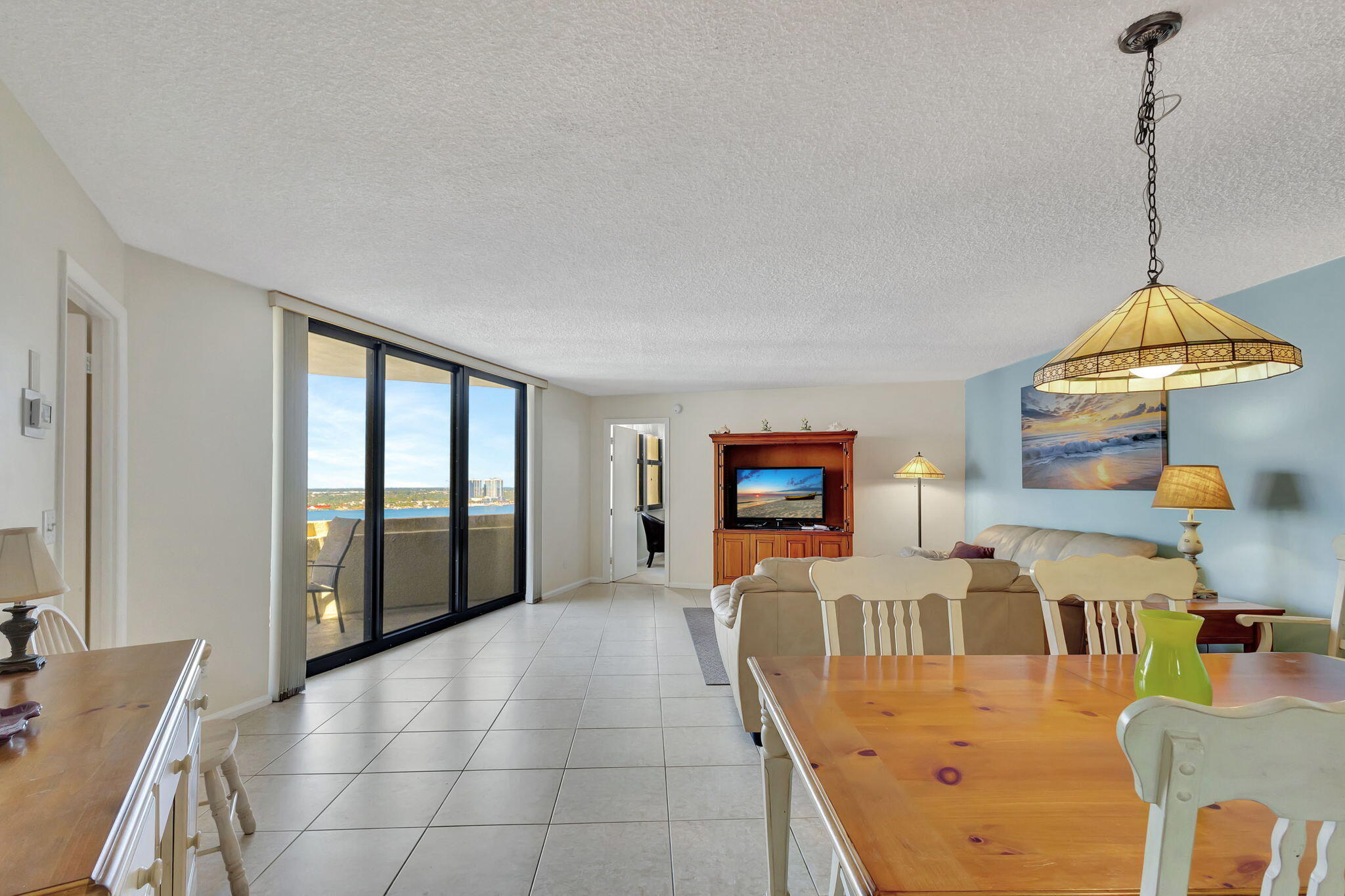 2800 North Ocean Drive, Unit A24B Singer Island, FL 33404 - Photo 4 of 65 a view of a livingroom with furniture wooden floor windows and a kitchen