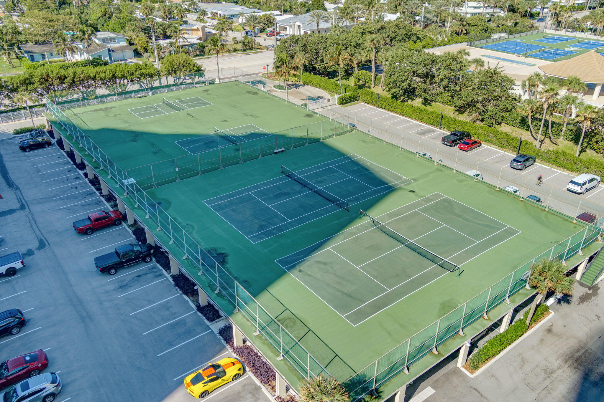 2800 North Ocean Drive, Unit A24B Singer Island, FL 33404 - Photo 41 of 65 a view of a tennis ground with large trees