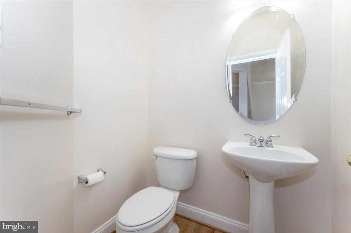 23029 Birch Mead Road Clarksburg, MD 20871 - Photo 13 of 30 a bathroom with a sink a mirror and a toilet