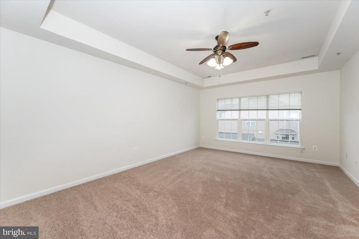 23029 Birch Mead Road Clarksburg, MD 20871 - Photo 14 of 30 an empty room with windows and ceiling fan