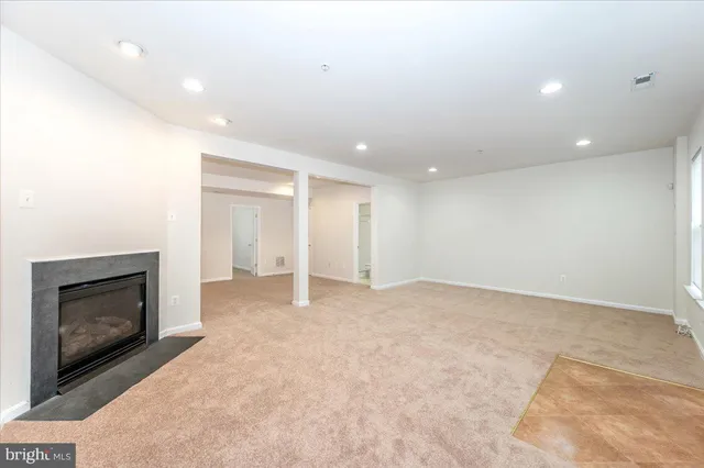 a view of empty room with a fireplace