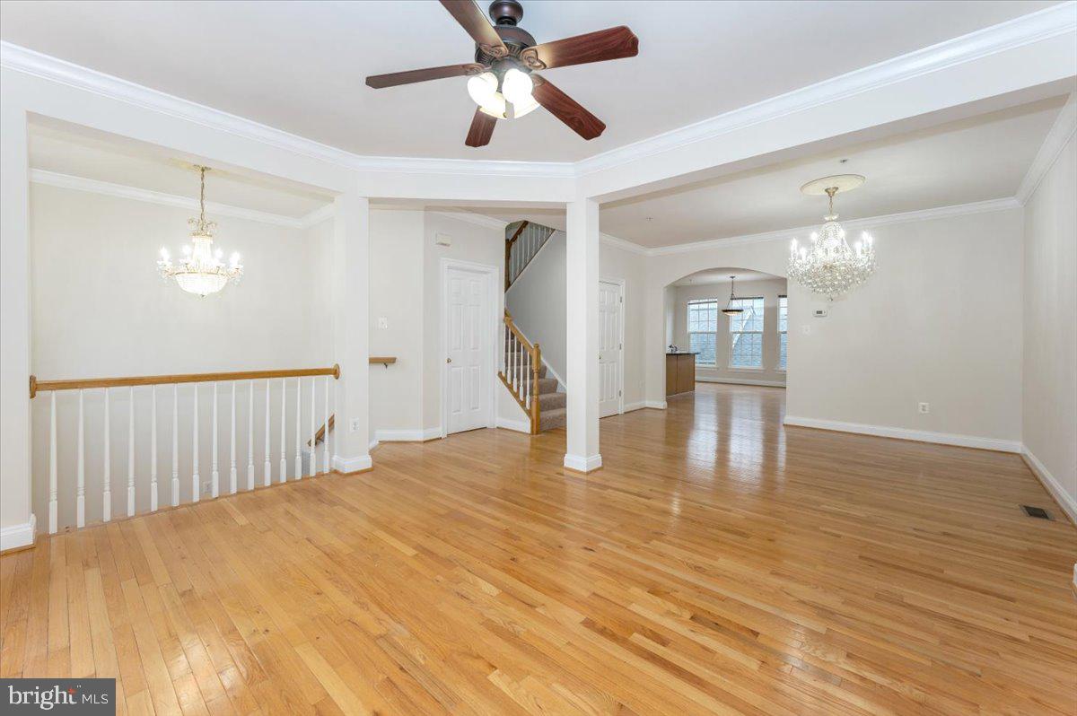 23029 Birch Mead Road Clarksburg, MD 20871 - Photo 3 of 30 a view of an empty room with wooden floor and a ceiling fan