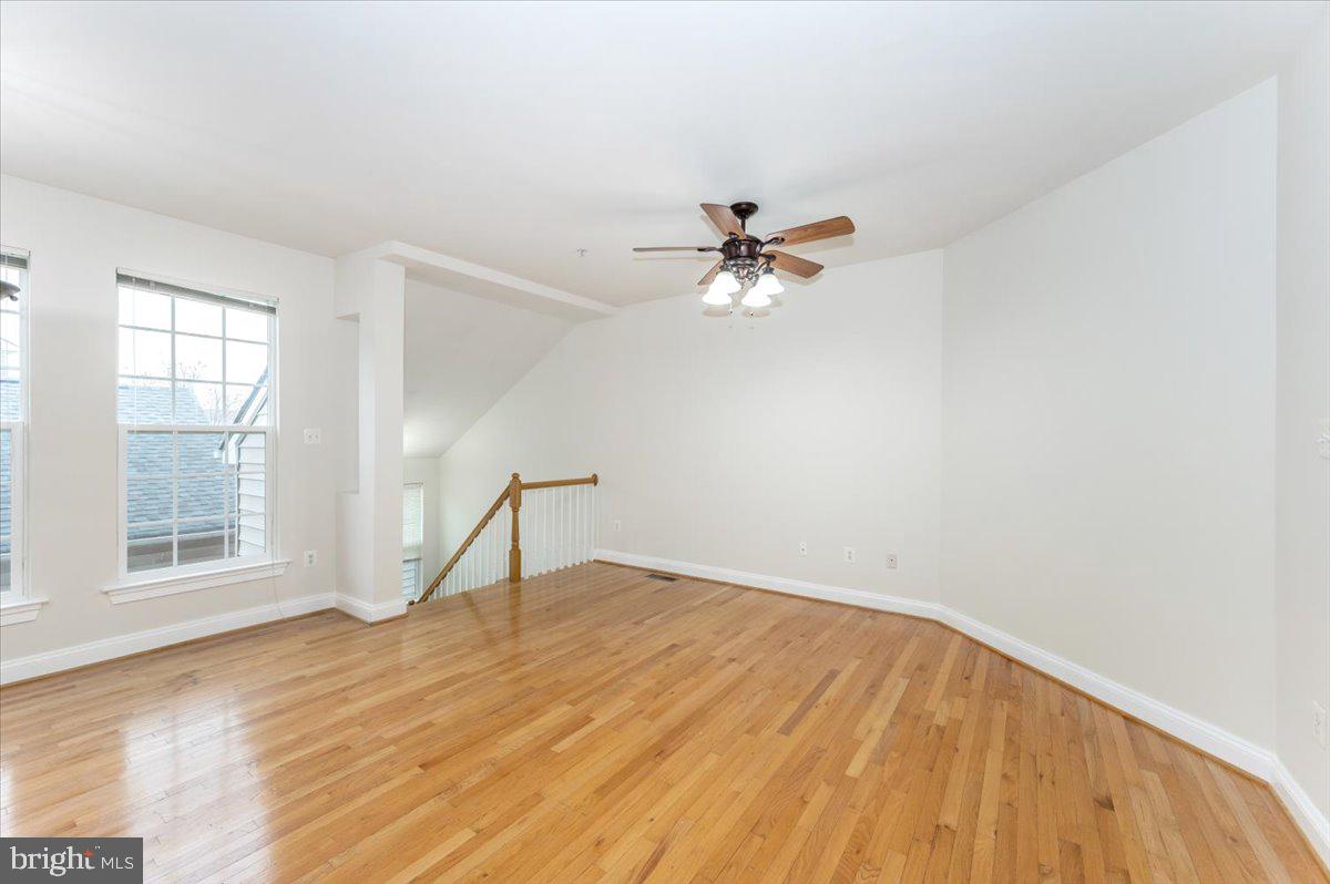 23029 Birch Mead Road Clarksburg, MD 20871 - Photo 6 of 30 a view of an empty room with wooden floor and a window
