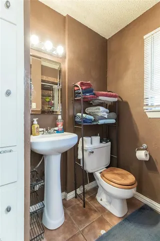 a bathroom with a sink toilet and mirror