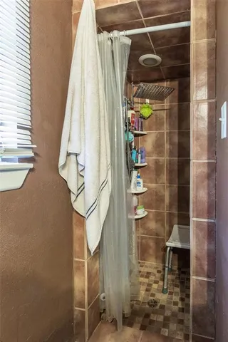 a bedroom with furniture and a flat screen tv