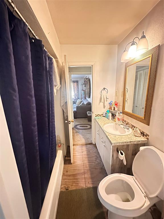 426 Goodyear Street Irving, TX 75062 - Photo 13 of 15 a bathroom with a granite countertop sink toilet a mirror and vanity