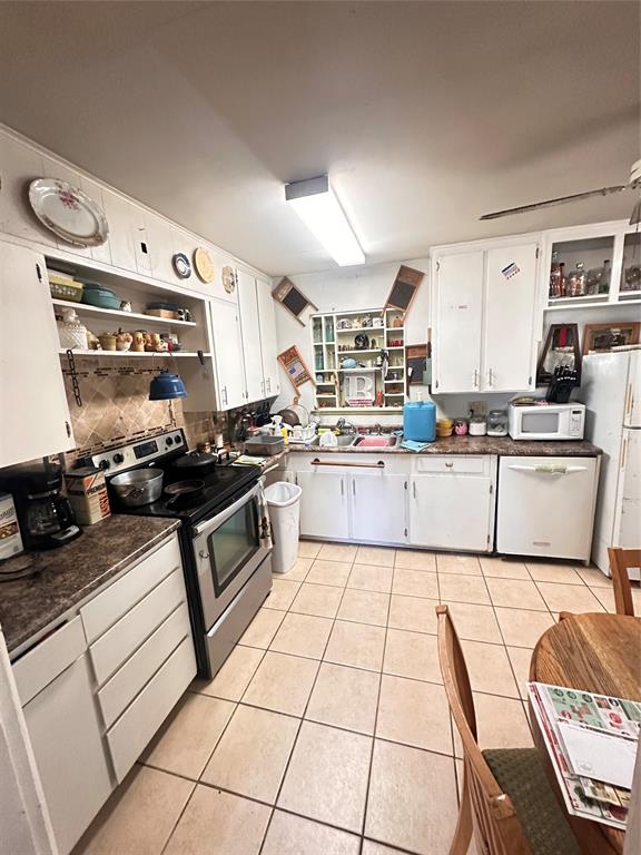 426 Goodyear Street Irving, TX 75062 - Photo 7 of 15 a kitchen with stainless steel appliances granite countertop a sink stove and cabinets