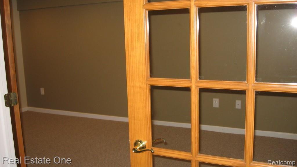 565 Timber Ridge Drive Highland, MI 48357 - Photo 39 of 55 EXTRA ROOM IN THE FINISHED LOWER LEVEL COULD BE USED AS 5TH BEDROOM OR WORKOUT ROOM.