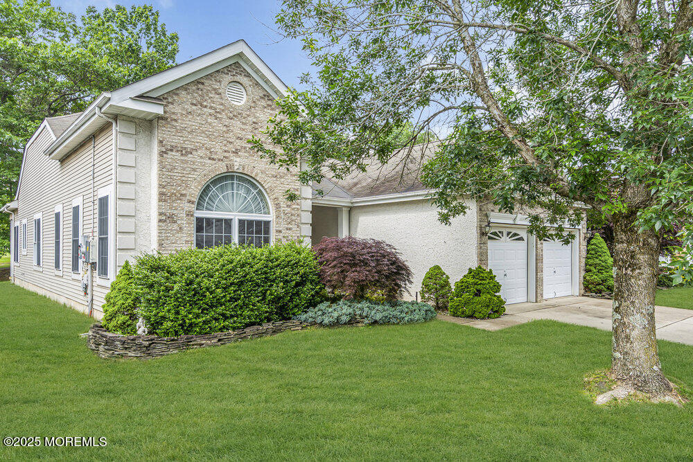 a front view of a house with a garden