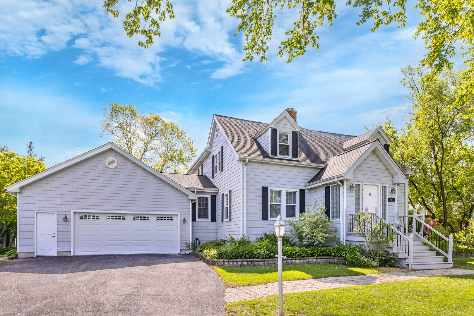a view of a house with a yard and a garden