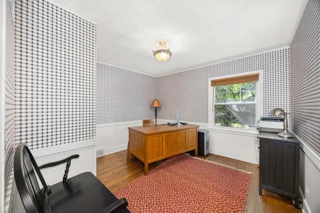 a living room with furniture rug and a window