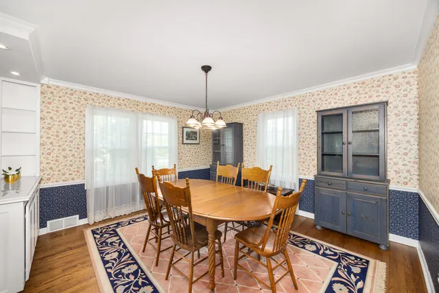 a dining room with furniture and window