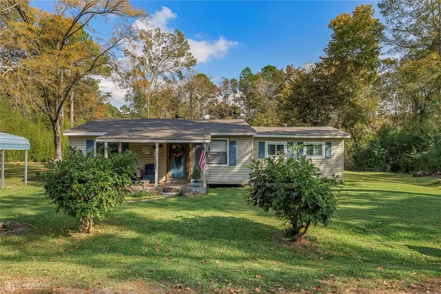 a front view of house with a garden
