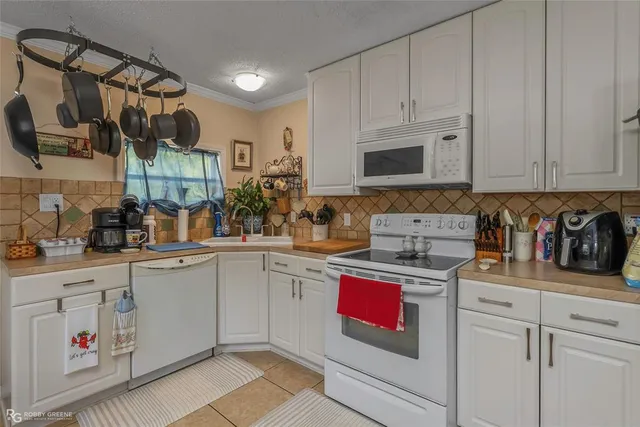 a kitchen with cabinets a sink and appliances