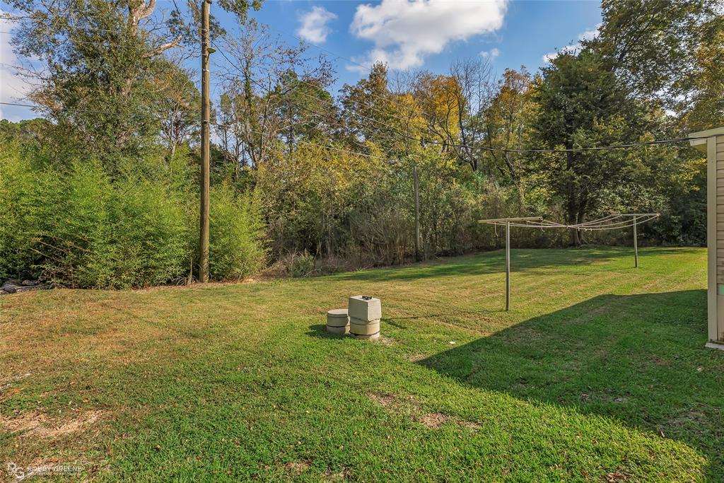 213 Bossier Street Heflin, LA 71039 - Photo 8 of 32 a swimming pool with lots of tress in the background
