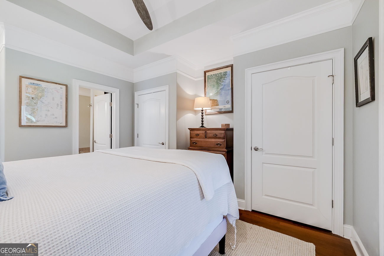 7272 Shellman Bluff Road Northeast, Unit 18 Townsend, GA 31331 - Photo 16 of 31 a bed room with a bed and a mirror