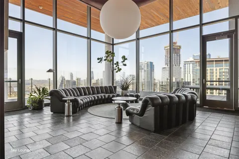 a living room with furniture and a floor to ceiling window