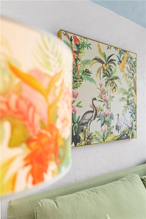 377 Vanderbilt Beach Road, Unit 102 Naples, FL 34108 - Photo 18 of 19 a view of a vase of flowers sitting on a table