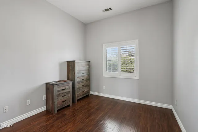 an empty room with wooden floor