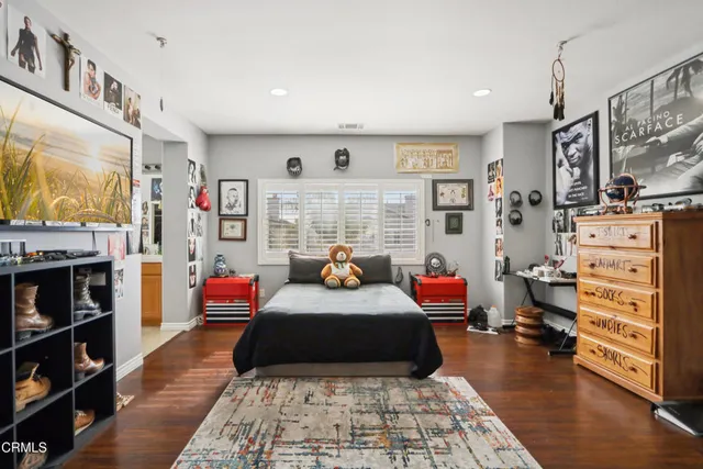 a bedroom with furniture and a flat screen tv