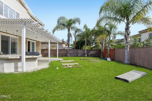 a view of a house with a yard patio and swimming pool