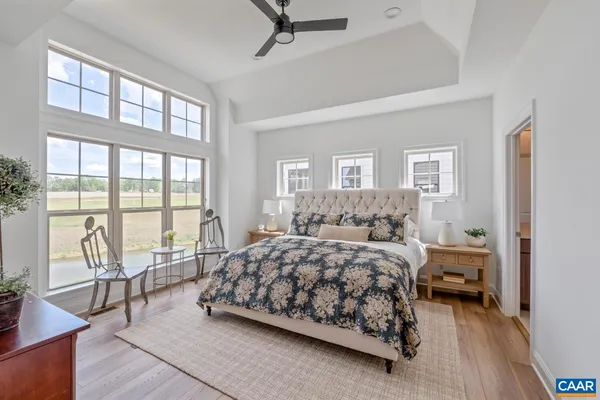 a bedroom with a bed and a large window