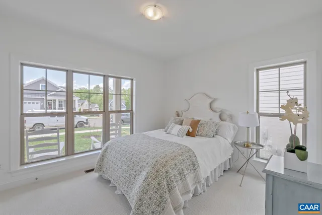 a bedroom with a large bed and a large window