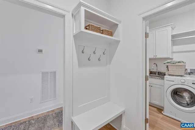 a view of a hallway with washer and dryer