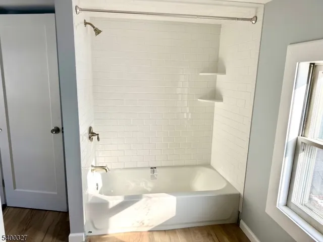 a bathroom with a tub and shower