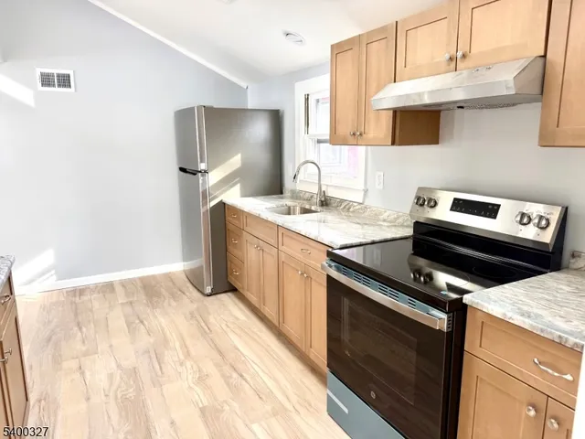 a kitchen with a stove microwave and sink