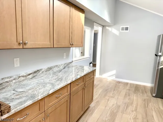 a view of a kitchen with granite countertop cabinets