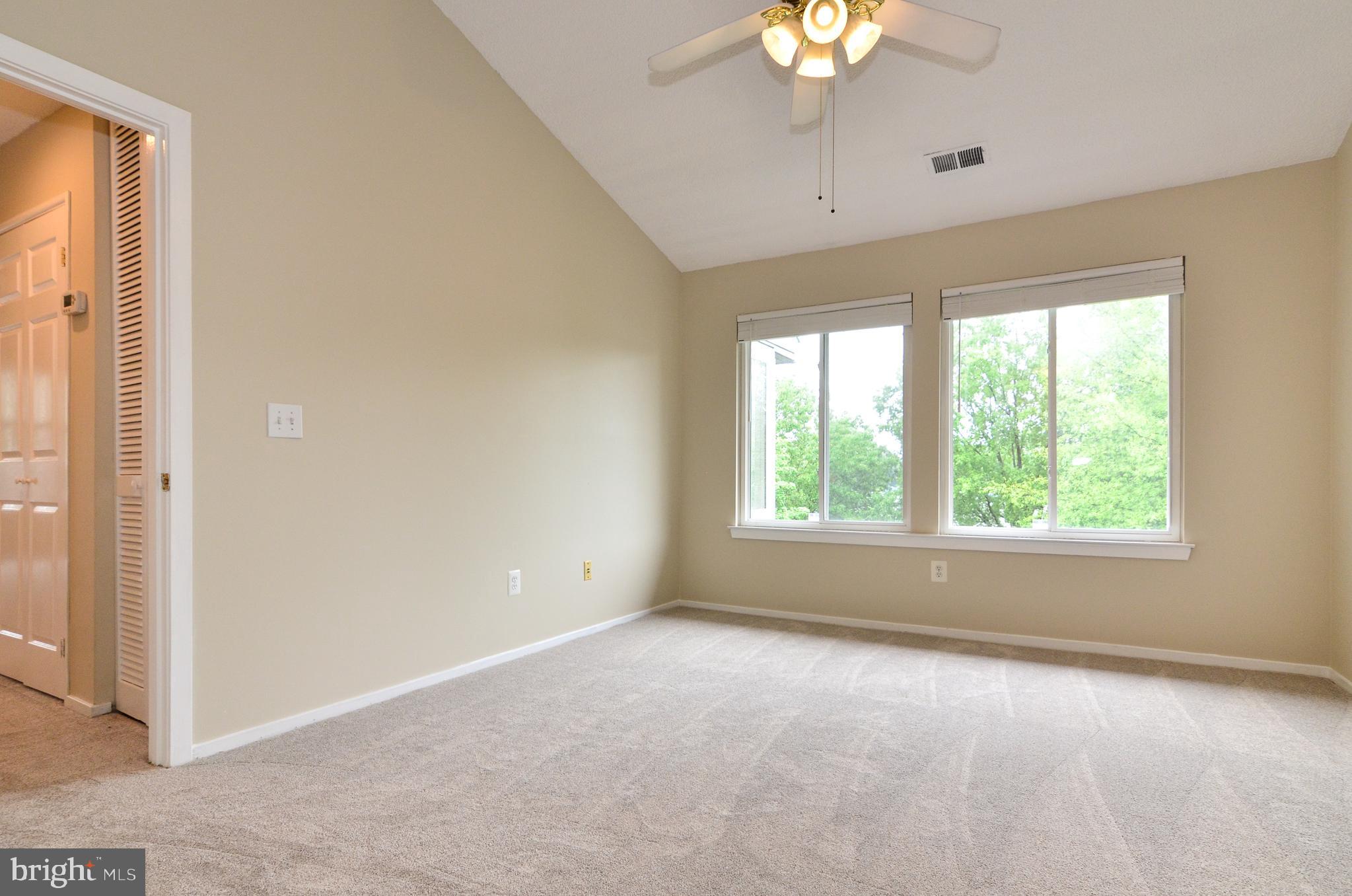 1500 Summerchase Court, Unit 1500E Reston, VA 20194 - Photo 15 of 26 Primary bedroom with vaulted ceiling