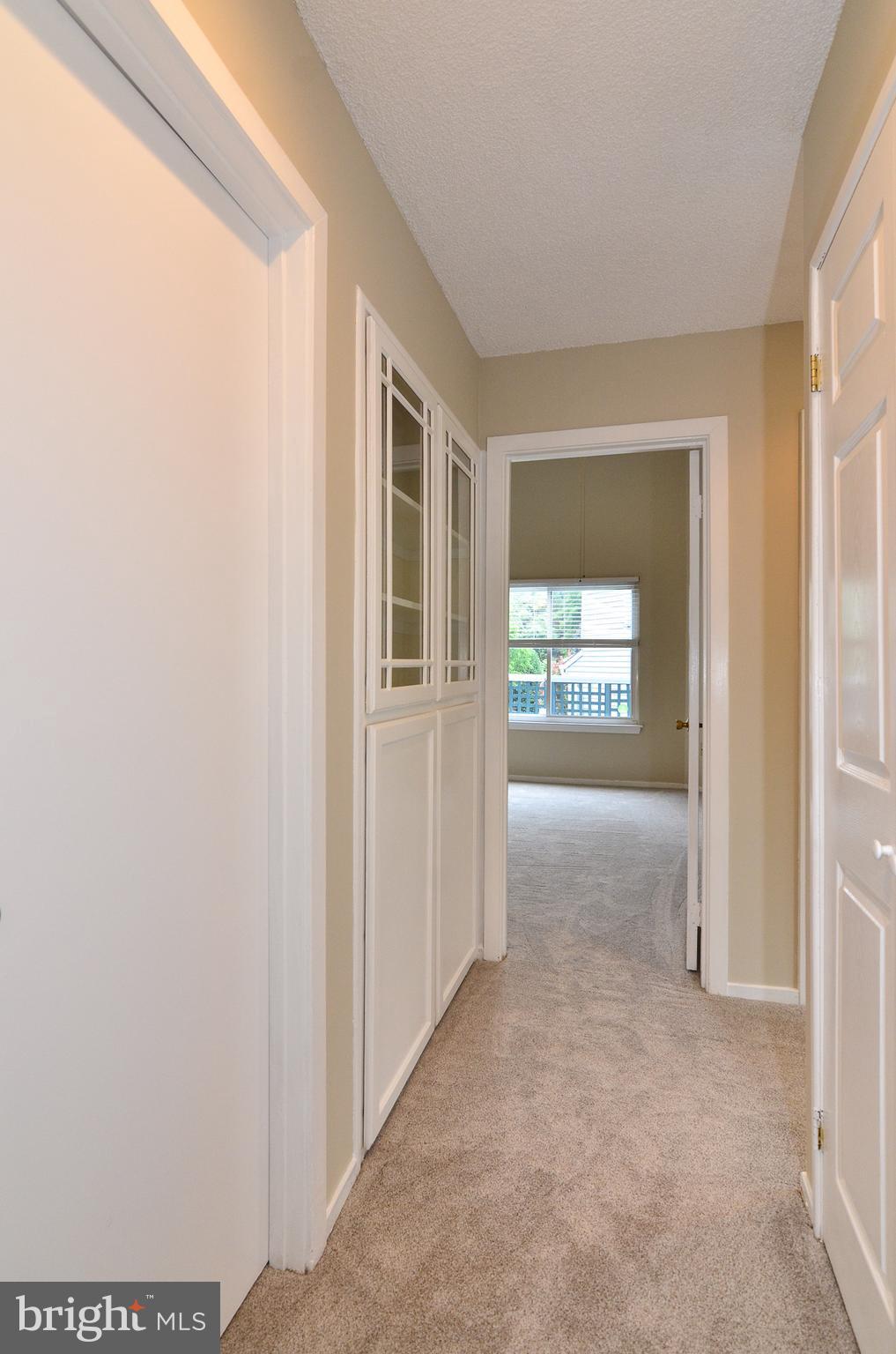 1500 Summerchase Court, Unit 1500E Reston, VA 20194 - Photo 23 of 26 Laundry closet and built-in display cabint