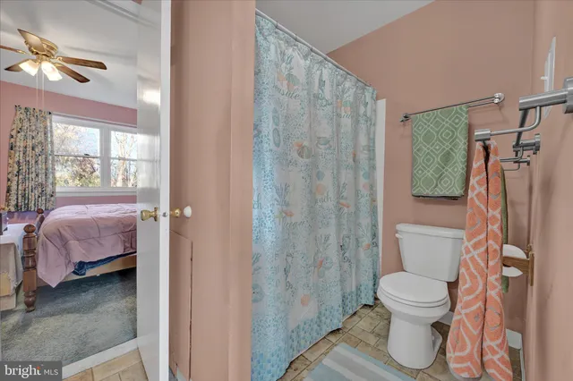 a bathroom with a toilet sink and shower