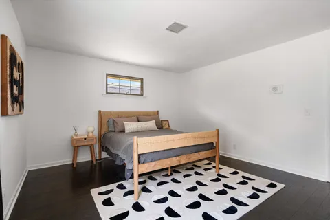 a bedroom with a bed and a potted plant