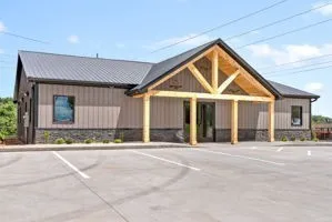 a front view of a house with basket ball court and garage