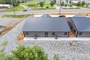 an aerial view of a house with a yard and sitting space