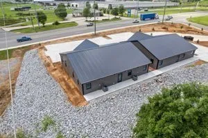 an aerial view of a house with a yard and lake view