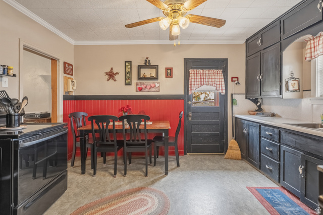 82 South 100 West Lyman, UT 84749 - Photo 24 of 27 Dining area featuring a ceiling fan, crown molding, and wainscoting
