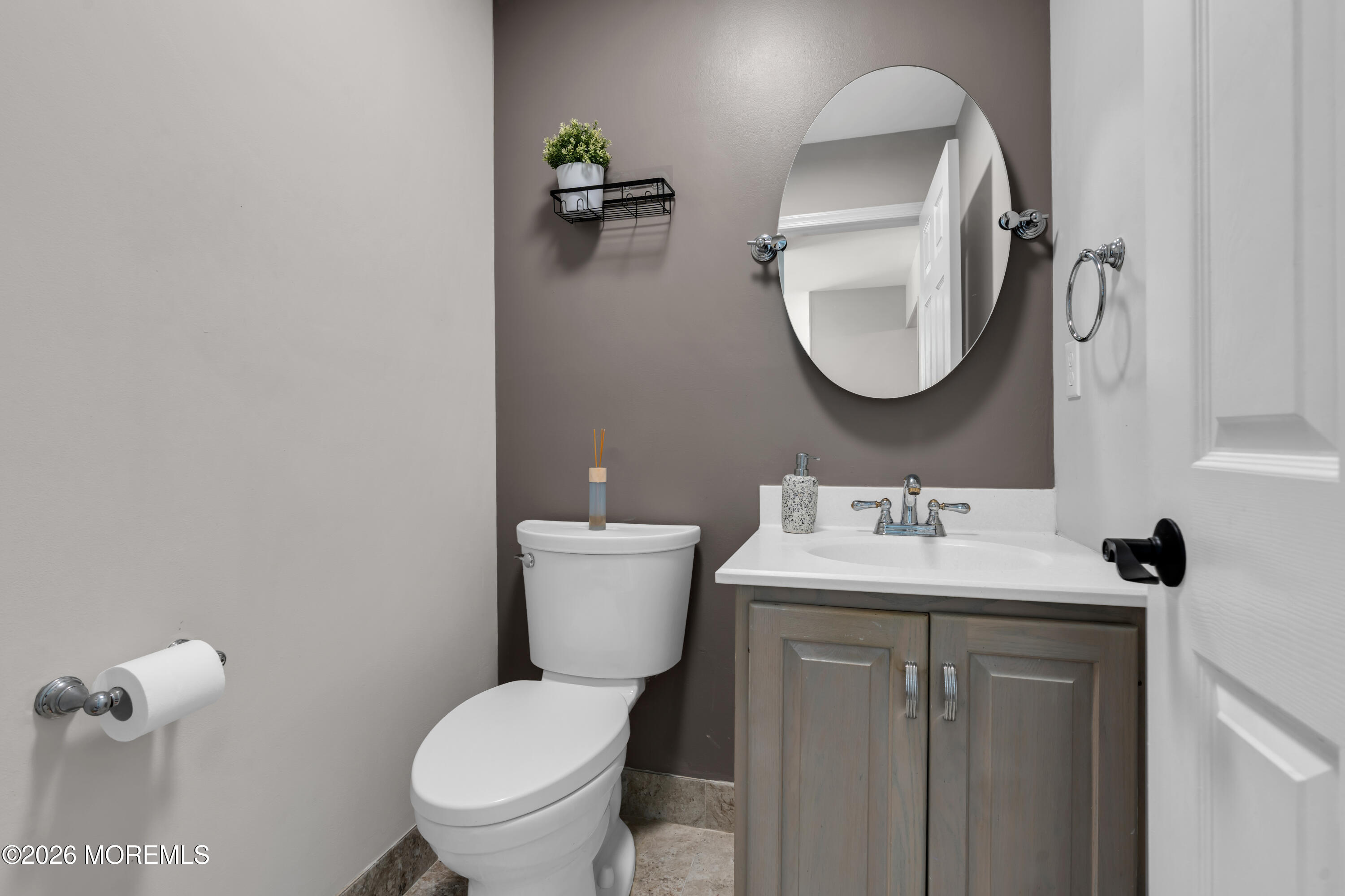 a bathroom with a toilet a sink and mirror